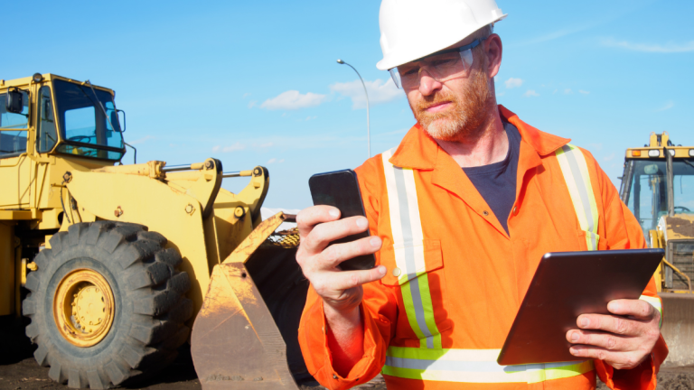 construction worker onsite using CMT software mobile device